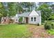 Charming home with gray siding, red front door, well-manicured lawn, and inviting curb appeal at 1098 Cascade Sw Cir, Atlanta, GA 30311
