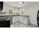 Bright kitchen with white cabinets, granite countertops, and stainless steel dishwasher at 1098 Cascade Sw Cir, Atlanta, GA 30311