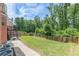 Expansive backyard with lush lawn, privacy fence, and patio deck at 118 Surge Stone Ln, Stockbridge, GA 30281