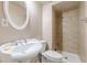 Updated bathroom features pedestal sink, tiled shower, and neutral walls at 118 Surge Stone Ln, Stockbridge, GA 30281
