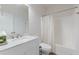 A bathroom features a modern vanity with white marble countertop and a shower with a curtain at 118 Surge Stone Ln, Stockbridge, GA 30281