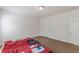An empty bedroom with carpeted floors, two windows, and doors to other rooms at 118 Surge Stone Ln, Stockbridge, GA 30281