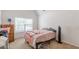 Bedroom featuring a neutral carpet, window, and vaulted ceiling at 118 Surge Stone Ln, Stockbridge, GA 30281