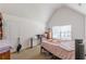 Bedroom featuring a neutral carpet, window, and vaulted ceiling at 118 Surge Stone Ln, Stockbridge, GA 30281
