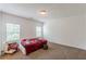 An empty bedroom with carpeted floors and two windows with natural light at 118 Surge Stone Ln, Stockbridge, GA 30281