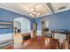 Elegant dining room with coffered ceilings, hardwood floors, and large windows at 118 Surge Stone Ln, Stockbridge, GA 30281