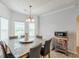 Dining room featuring natural light, simple chandelier, and view to kitchen at 118 Surge Stone Ln, Stockbridge, GA 30281