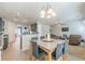 Spacious dining area with a modern table set, view into the living room, and access to the kitchen at 118 Surge Stone Ln, Stockbridge, GA 30281