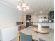 Cozy dining room with a view of the kitchen, modern lighting, and ample natural light at 118 Surge Stone Ln, Stockbridge, GA 30281