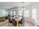 Bright dining area featuring a modern table set, chair rail detail, and large windows at 118 Surge Stone Ln, Stockbridge, GA 30281
