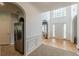 Bright entryway with hardwood floors, a high ceiling, and an archway into another room at 118 Surge Stone Ln, Stockbridge, GA 30281