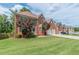 Two-story brick home with a well-manicured lawn and trees providing shade and curb appeal at 118 Surge Stone Ln, Stockbridge, GA 30281