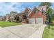 Two-story brick home featuring a basketball hoop and an extended driveway at 118 Surge Stone Ln, Stockbridge, GA 30281