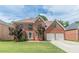 Traditional brick home with a two-car garage and manicured lawn at 118 Surge Stone Ln, Stockbridge, GA 30281