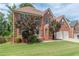 Charming brick two-story home with mature trees and a well-manicured lawn at 118 Surge Stone Ln, Stockbridge, GA 30281