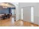 Foyer featuring hardwood floors, a cased opening to dining room with coffered ceiling, and wainscotting at 118 Surge Stone Ln, Stockbridge, GA 30281