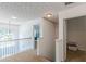 Upstairs hallway with modern chandelier and carpeted floors at 118 Surge Stone Ln, Stockbridge, GA 30281