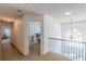 Second floor hallway with carpet and view of chandelier at 118 Surge Stone Ln, Stockbridge, GA 30281