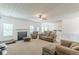 Comfortable living room featuring a fireplace, large windows, and lots of seating for Gathering and friends at 118 Surge Stone Ln, Stockbridge, GA 30281