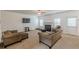 Cozy living room with a fireplace, neutral carpet, plush seating, and a door to the backyard at 118 Surge Stone Ln, Stockbridge, GA 30281