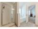 Bright bathroom featuring glass shower and soaking tub with modern fixtures at 118 Surge Stone Ln, Stockbridge, GA 30281