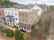 Aerial view of a row of townhomes with manicured landscaping and mature trees in a suburban setting at 2026 Forte Lane, Alpharetta, GA 30009