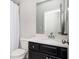 Cozy bathroom with a vanity, a modern sink, stylish hardware, and a tub-shower with white tiling at 2026 Forte Lane, Alpharetta, GA 30009