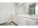 Modern bathroom with double sink vanity, large mirror, white cabinets, and tiled floor at 2026 Forte Lane, Alpharetta, GA 30009