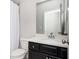 Bathroom featuring a vanity with a white top and dark cabinet, brushed metal fixtures, a toilet and a shower with a white curtain at 2026 Forte Lane, Alpharetta, GA 30009