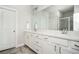Bathroom featuring double sinks, white cabinets, a large mirror and a glass door shower at 2026 Forte Lane, Alpharetta, GA 30009
