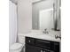 Updated bathroom with dark vanity, white marble counter and tub shower with white curtain at 2026 Forte Lane, Alpharetta, GA 30009