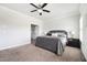 Spacious bedroom featuring a ceiling fan, carpet flooring, and an attached bathroom for added convenience at 2026 Forte Lane, Alpharetta, GA 30009
