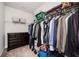 Walk-in closet featuring shelving, clothing, and a dark wood dresser for storage at 2026 Forte Lane, Alpharetta, GA 30009