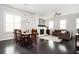 Open-concept living area with a dining table and chairs near the living room fireplace at 2026 Forte Lane, Alpharetta, GA 30009