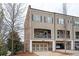 Beautiful townhouse featuring a two-car garage and balcony overlooking the landscaped grounds at 2026 Forte Lane, Alpharetta, GA 30009