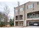 Charming townhome exterior featuring a two-car garage, balcony, and neutral color palette at 2026 Forte Lane, Alpharetta, GA 30009