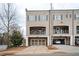 Charming townhouse featuring an attached two-car garage and spacious front-facing balcony at 2026 Forte Lane, Alpharetta, GA 30009