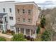 Stately brick townhome with a covered porch and manicured landscaping, offering timeless appeal and charm at 2026 Forte Lane, Alpharetta, GA 30009