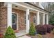 Charming brick home featuring a welcoming front porch and manicured landscaping at 2026 Forte Lane, Alpharetta, GA 30009