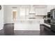 Modern kitchen with white cabinetry, stainless steel appliances, and a large center island at 2026 Forte Lane, Alpharetta, GA 30009
