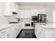 Modern kitchen featuring white cabinets, stainless steel appliances, and marble countertops at 2026 Forte Lane, Alpharetta, GA 30009