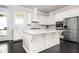 Bright kitchen with white cabinets, stainless steel appliances, and a kitchen island at 2026 Forte Lane, Alpharetta, GA 30009