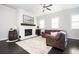 Cozy living room featuring a fireplace, modern furnishings, and hardwood floors at 2026 Forte Lane, Alpharetta, GA 30009