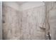 Shower with stone-look tile surround, a built in seat, and an adjustable shower head at 2026 Forte Lane, Alpharetta, GA 30009