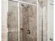 Modern shower featuring stylish tile, showerhead, and glass door at 2026 Forte Lane, Alpharetta, GA 30009