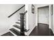 Bright staircase with dark wood treads, iron spindles, and a white-painted riser leads to the upper level at 2026 Forte Lane, Alpharetta, GA 30009