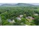 Aerial view of a home nestled within a lush forest and mountain view at 515 Saint Barbaras Nw Ln, Marietta, GA 30064