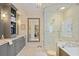 Elegant bathroom with a glass-enclosed shower, soaking tub, and custom vanity with marble countertops and stylish fixtures at 515 Saint Barbaras Nw Ln, Marietta, GA 30064