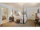 Luxurious bedroom with a four-poster bed, chandelier, and en-suite bathroom, providing a private retreat at 515 Saint Barbaras Nw Ln, Marietta, GA 30064