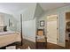 Comfortable bedroom featuring a four-poster bed, rocking chair, and attached bathroom for convenience and privacy at 515 Saint Barbaras Nw Ln, Marietta, GA 30064